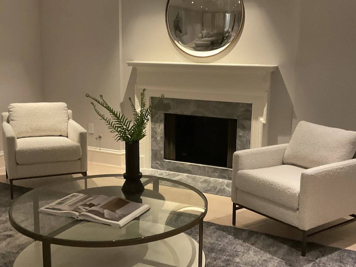 Stone surround within a white fireplace mantel in a finished living room